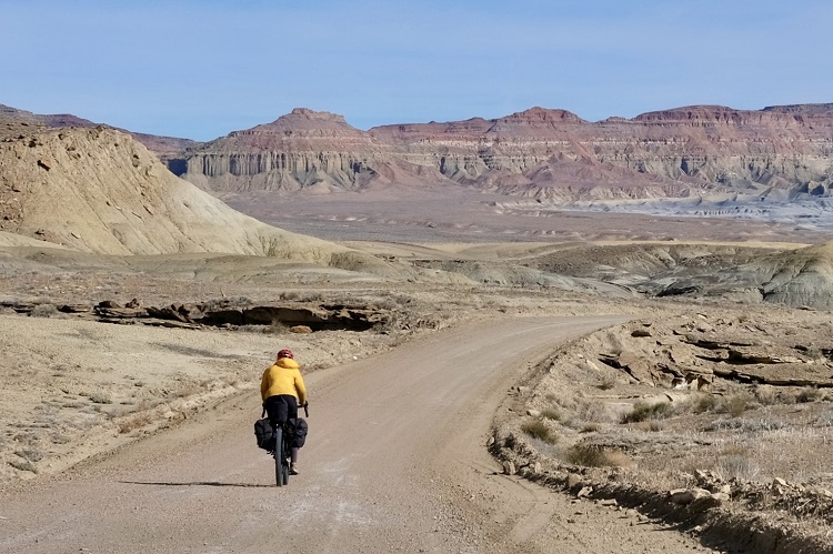 Cyclist biking on road on Utah’s Grand Staircase Loop